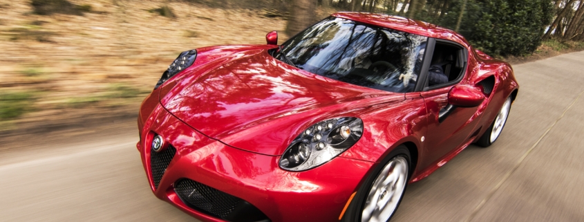 Red alfa romeo c4 on road near trees